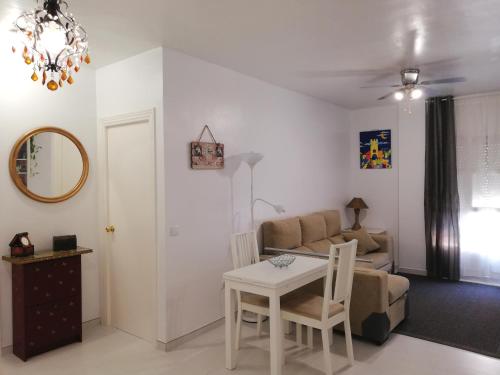 a living room with a table and a couch at APplaya in El Puerto de Santa María