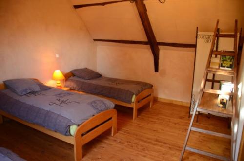 a room with two beds and a ladder in it at La Ferme du Père in Kermorocʼh