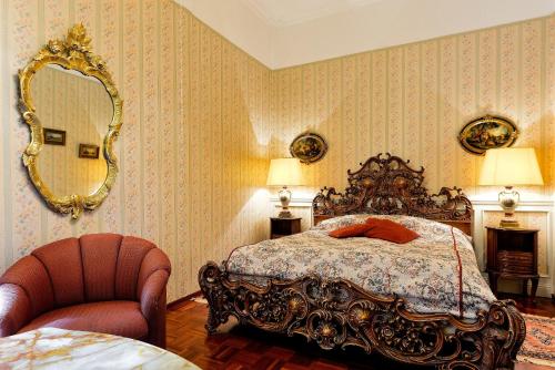a bedroom with a bed and a mirror and a chair at Park Hotel Turku in Turku