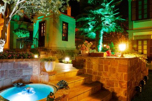 a house with a bath tub in a yard at night at YundAntik Cunda Konaklari in Ayvalık