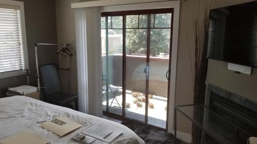 a bedroom with a sliding glass door to a patio at Gondola Lodge & Tahoe Beach Club in South Lake Tahoe