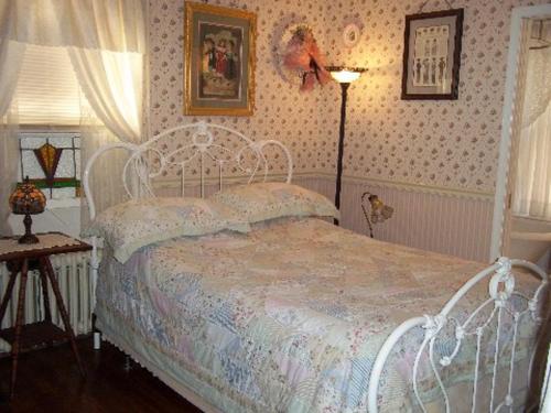 a bedroom with a white bed and a lamp at A Sentimental Journey in Gettysburg
