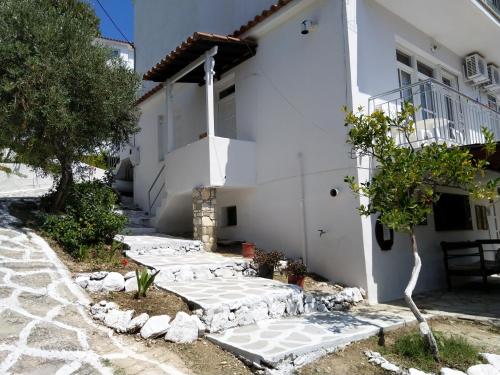 a white house with a path leading up to it at Amaranthos Skiathos View in Megali Ammos