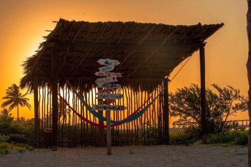 a bunch of signs in front of a gate at Hotel La Casa Cielo solo adultos in El Cuyo
