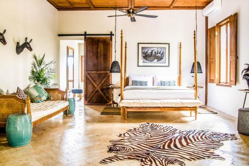 a living room with a bed and a zebra rug at Villa Pulau Cinta Boutique Suites in Gili Meno