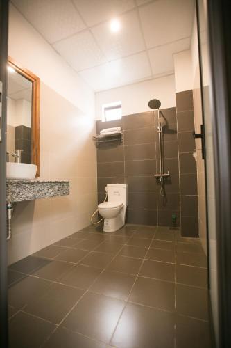 a bathroom with a toilet and a sink at Yen villa Hội An in Hoi An