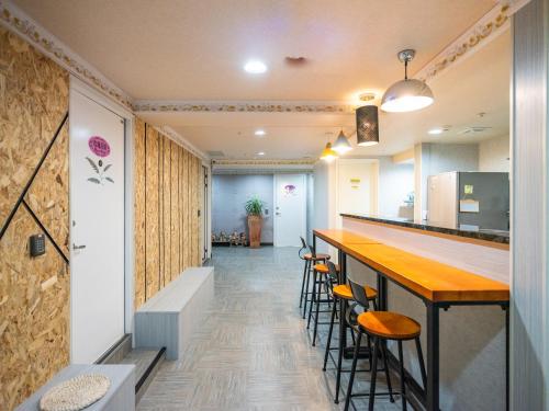 an office corridor with a bar and stools at Gwawa Hotel in Kaohsiung
