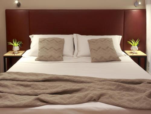 Postel nebo postele na pokoji v ubytování Hotel Aloisi