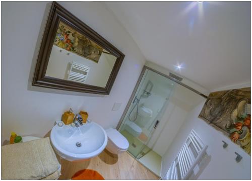 a bathroom with a toilet and a sink and a shower at VILLA VINICIA, pool, jacuzzi, airco in Domaso