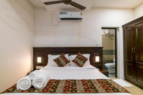 a bedroom with a bed with towels on it at Warmth Lake Haven in Alleppey