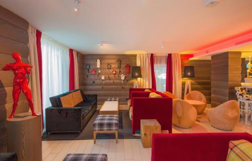 a living room with a couch and a table at Agora Swiss Night by Fassbind in Lausanne