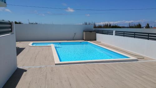 a swimming pool on the roof of a house at Vitamin Sea, The Terrace Apartment in Baleal