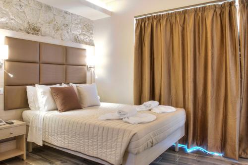 a hotel room with a bed with towels on it at Porto Demo Hotel in Agios Georgios Pagon