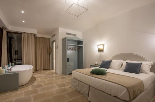 a bedroom with a large bed and a bath tub at Romantic Relais Sorrento in Sorrento
