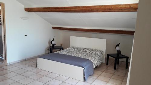 a bedroom with a bed and two side tables at Casa di Caucana in Santa Croce Camerina