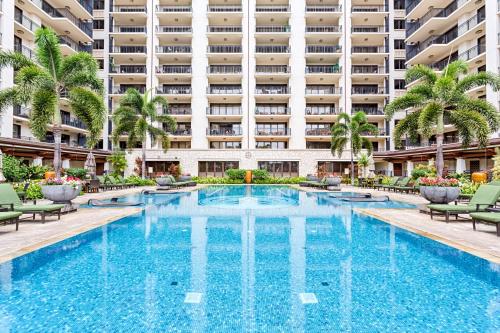 a swimming pool in front of a large building at Spacious Fourth Floor Villa with Pool View - Ocean Tower at Ko Olina Beach Villas Resort in Kapolei