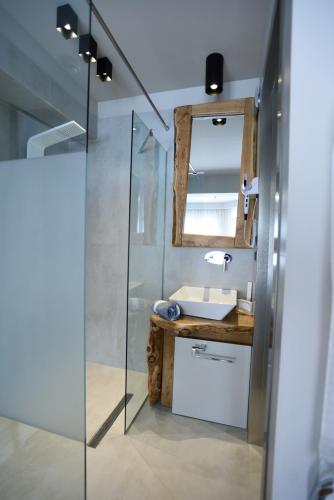 a bathroom with a sink and a mirror at Magnifique Luxury Suites in Thessaloniki