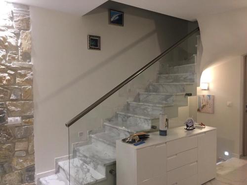 a room with a staircase with a stone wall at Villa Stephanie in Hanioti