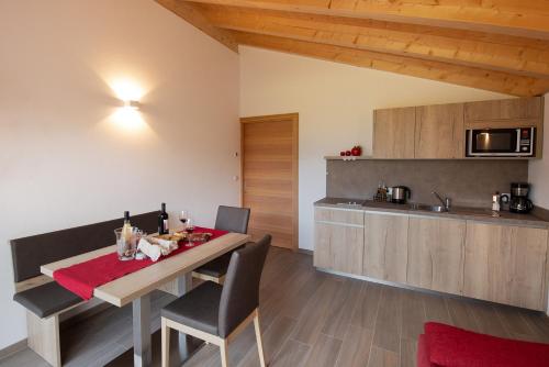 a kitchen and dining room with a table and chairs at Bauernhof Residence Hausergut with Ortler views, central and quiet position in Sluderno