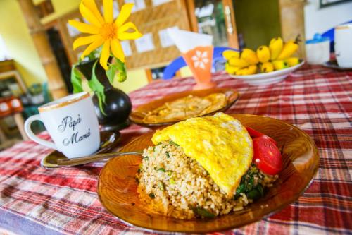 a table with a plate of food on a table at Kembang Kuning Cottages in Tetebatu