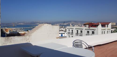 a blue bench sitting on top of a building at Hotel Maram in Tangier