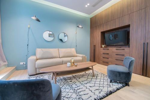 a living room with a couch and a tv at Résidence du Marais - Paris Center in Paris