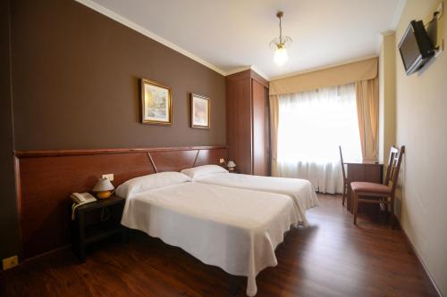 Postel nebo postele na pokoji v ubytování Hospedaxe A Vila