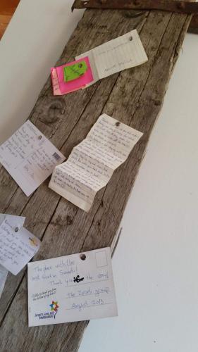 a wooden table with handwritten notes on it at Guesthouse Angelina in Ushguli