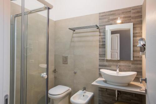a bathroom with a sink and a toilet and a shower at B&B In Centro in Vieste
