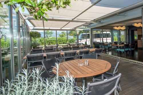 a restaurant with a wooden table and chairs at Gasthof Seefeld in Hurden