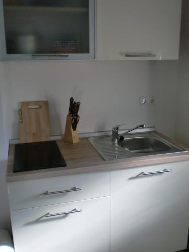a kitchen with a sink and a counter top at Villa Santa Barbara in Vrsi