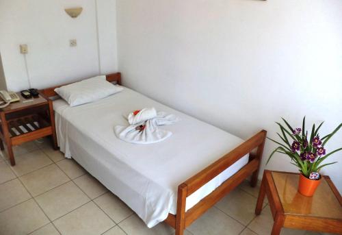 a bedroom with a bed with a plate on it at Poseidon Hotel in Heraklio Town