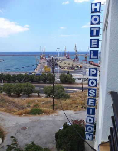a sign for a building with a view of the ocean at Poseidon Hotel in Heraklio Town