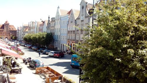 a city street with cars parked on the street at Apartament MARIA in Gdańsk