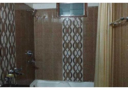 a bathroom with a shower with a shower curtain at Hotel Pratiksha in Solan