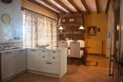 a kitchen with a table and a dining room at Luxury Villa Esmeralda in Suances