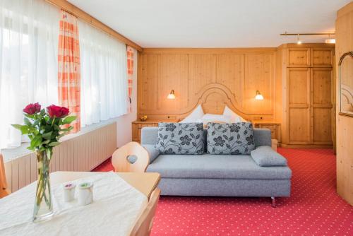 a living room with a couch and a table at Hotel Tiroler Herz in Hinterhornbach