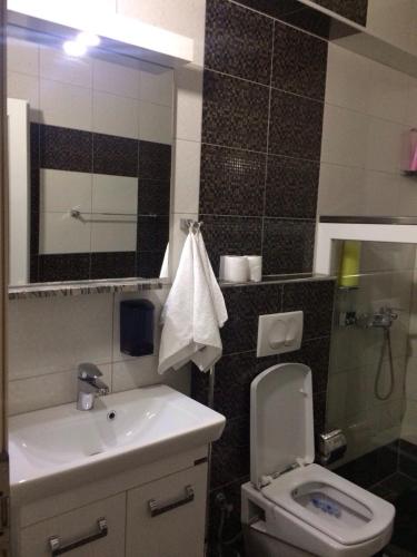 a bathroom with a toilet and a sink at Hotel Millenium2 in Prizren