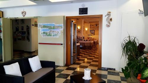 a living room with a checkered floor at Hotel Marietta in Caorle