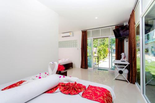 a bedroom with a bed and a large window at Phi Phi Maiyada Resort in Phi Phi Don