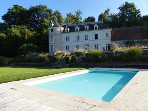 a large swimming pool in front of a house at Gite de la Vigneraie in Athée-sur-Cher