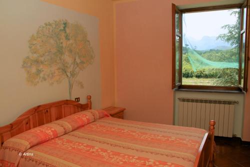 A bed or beds in a room at Agriturismo La Praduscella