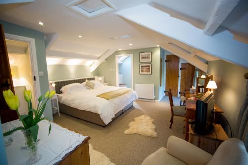 a bedroom with a bed and a living room at Errington House in Hexham