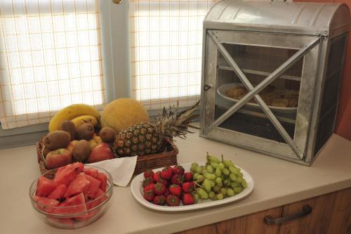 a bunch of fruits and vegetables on a counter at Scala Apartments in Kastraki Naxou