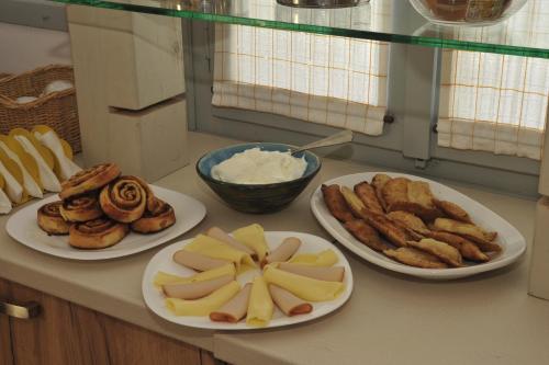 three plates of food on a counter with pastries at Scala Apartments in Kastraki Naxou