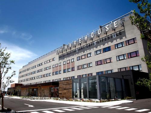 a building with a sign on the top of it at Kawasaki King Skyfront Tokyu REI Hotel in Kawasaki