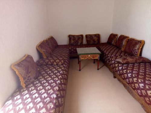 a living room with a couch and a table at Maison Saadia in Rabat