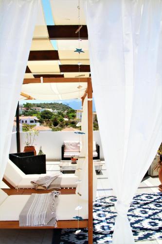 a room with a balcony with white curtains at Villa Dionysos in Plaka