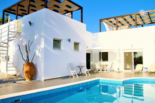 a villa with a swimming pool and a house at Villa Dionysos in Plaka