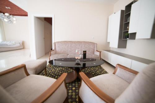 a living room with a table and two chairs at Hotel Urban in Bužim